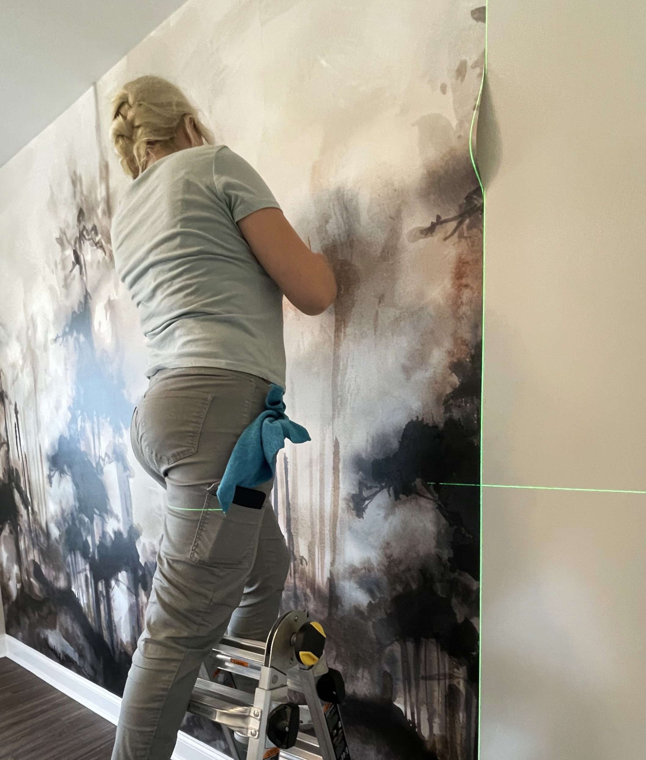 Natalia installing patterned wallpaper